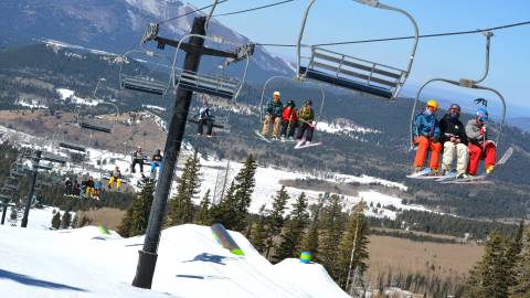 skiers riding ski lift